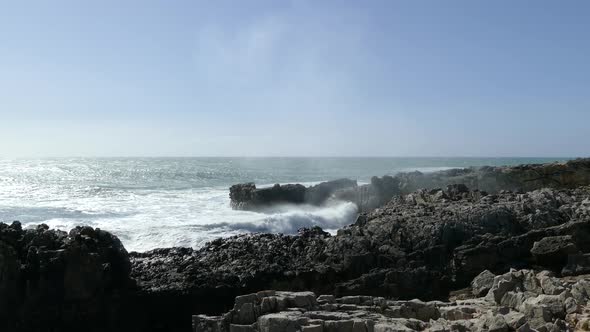 Waves smashing to the rocky coast of Sintra-Cascais Natural Park 