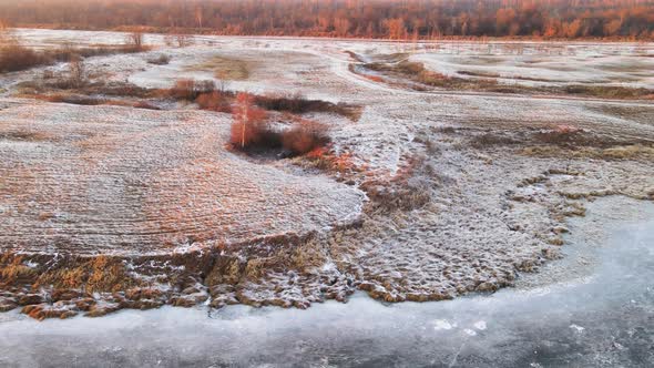 Orange Coast of the Lake Covered with Frost Aerial View