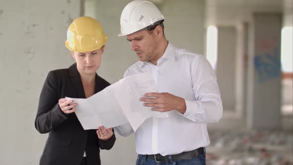 Architect Team Man and Woman Discussing About Building Plan for Construction at Job Site