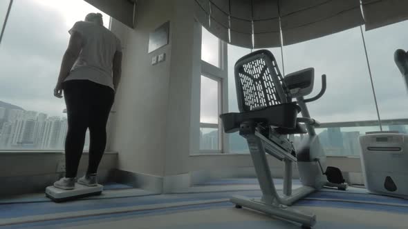 Woman weighing on scales in the gym