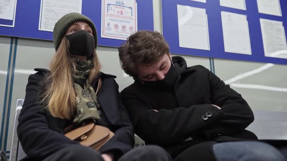 A Man in a Mask Falls Asleep and Puts His Head on His Shoulder to an Unfamiliar Woman