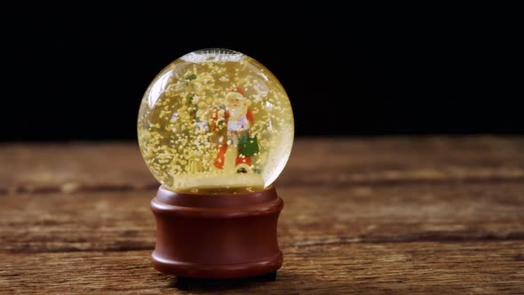 Christmas crystal ball on wooden table