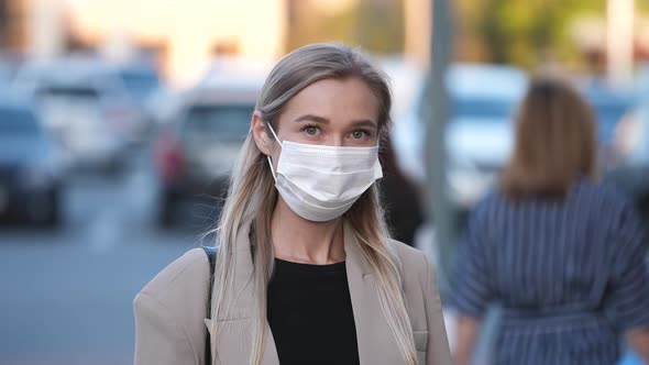 Casual Looking Blonde Lady on City Streets with Covered Face Covid19 Facemask