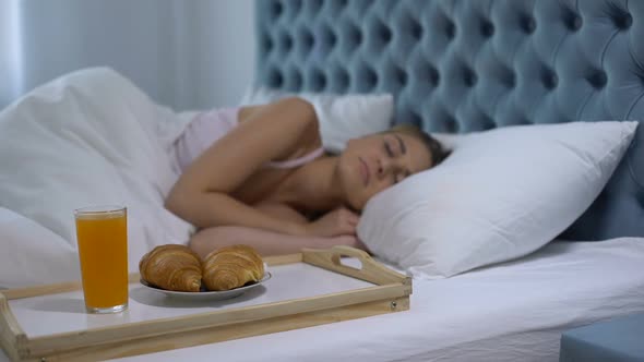 Girl Sleeping in Hotel Room, Ready Breakfast on Tray Near Bed, Five Star Service