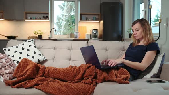 Woman Lying on Sofa and Use Laptop