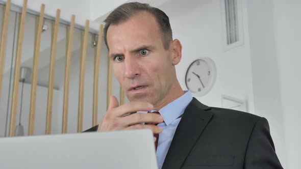 Shocked Middle Aged Businessman Working on Laptop Astonished