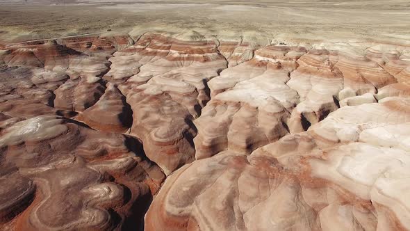 Rising aerial view over eroded desert in the desert