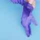 Doctor putting on protective medical latex gloves to protect - VideoHive Item for Sale