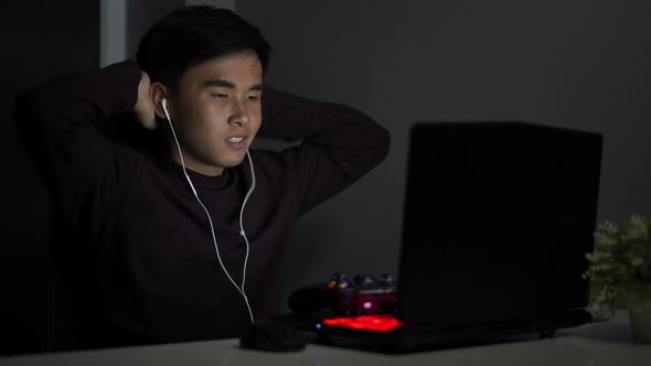 Stressed depressed young man using joystick to playing games