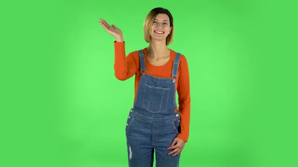 Happy Woman Waving Hand in the Studio. Green Screen