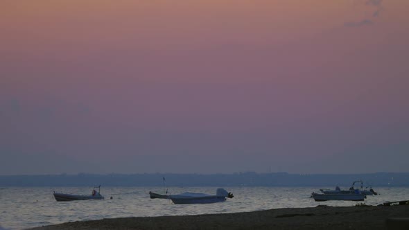 Moored Motor Boats Rocking on Sea Waves in the Dusk