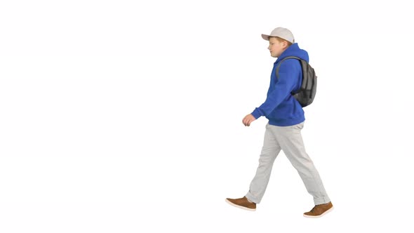 Young Boy Wearing a Backpack Walking To School on White Background