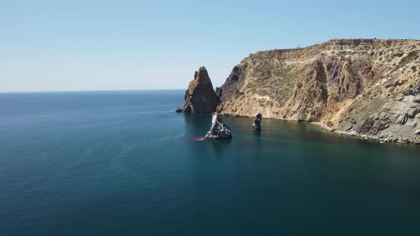 Aerial View From Above on Calm Azure Sea and Volcanic Rocky Shores