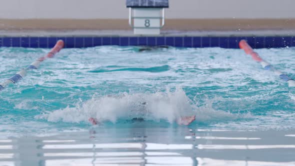 Swimmer swimming into the pool