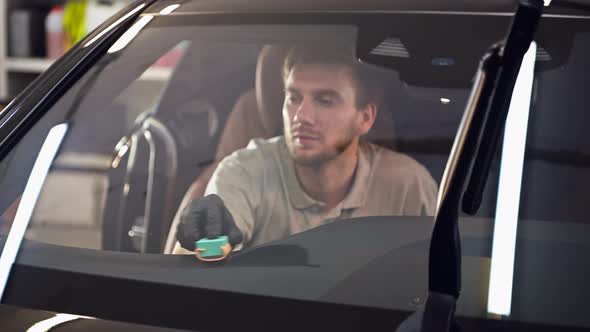 Professional Car Dashboard Cleaning with Special Sponge, Applying Protective Coating Inside the Car.