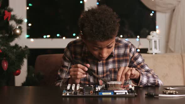 Afro Boy Fixing Motherboard.