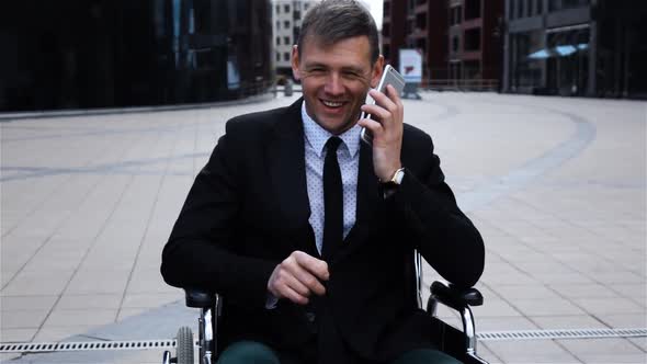 Disabled Invalid Businessman Talking By Smartphone