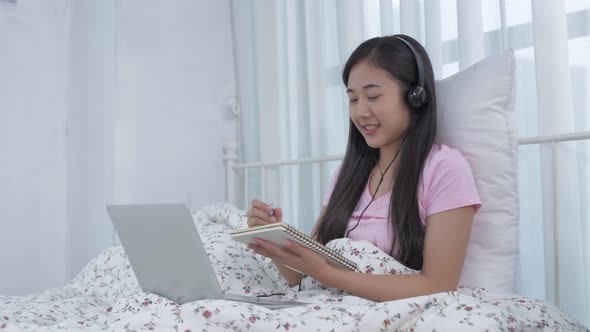 Work from home concept. Asian young woman communicating video call through notebook. 4k Resolution.