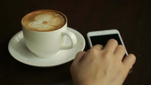 Using Smartphone With Coffee