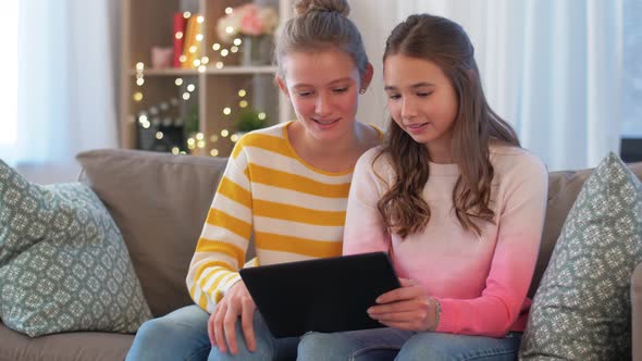 Happy Teenage Girls with Tablet Computer at Home