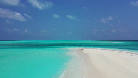 Luxury aerial copy space shot of a sandy white paradise beach and aqua blue water background in 4K