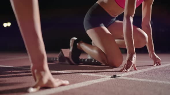 Woman Hand on Track As He Crouches in Starting Position at the Beginning of a Race