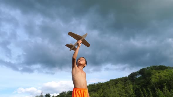 Happy Kid Playing With Toy Airplane 