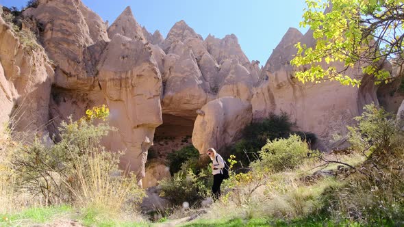 Woman Stands in Middle of Mountains and Hills and Thinks Where to Go