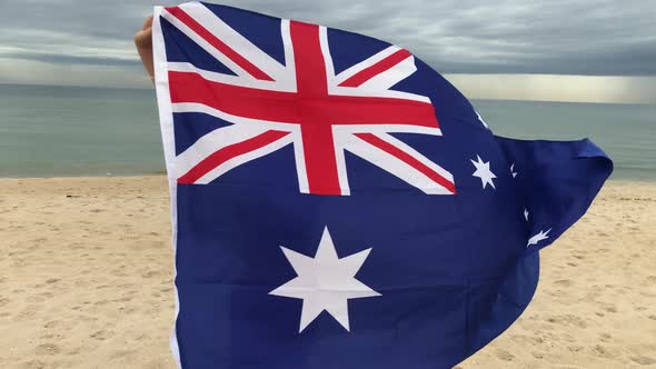 Smiling Middle Age Woman Waving Australian Flag and Spinning Around