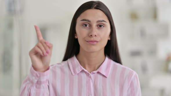 Portrait of Attractive Young Latin Woman Saying No By Finger