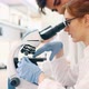 Young Scientist Looking Through Microscope in Laboratory - VideoHive Item for Sale
