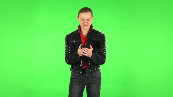 Happy Guy Texting on His Phone, Green Screen