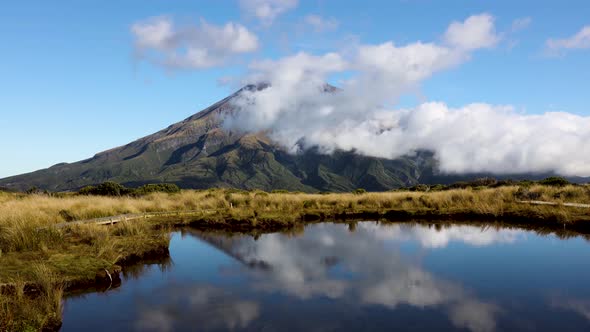 Tight shot time lapse of clouds rolling around Mount Taranaki. Shot with reflection from the Pouakai