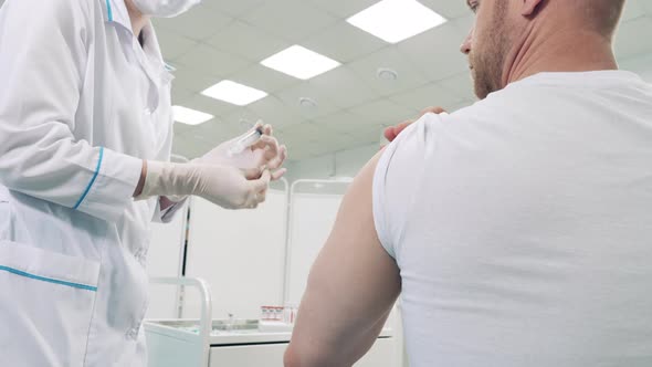 Medical Worker is Vaccinating a Patient Against Coronavirus