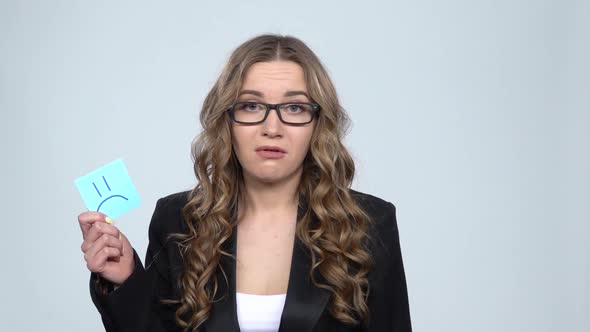 Lady Holding Paper Stick Expressing Awful Mood Then Takes Another Expressing Good Mood, Slow Motion