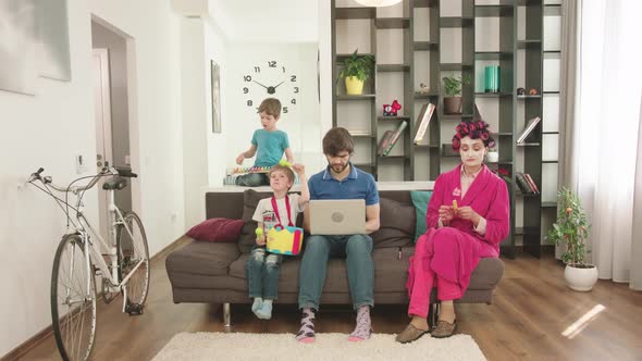 Modern Parents Looks After The Children At Home.