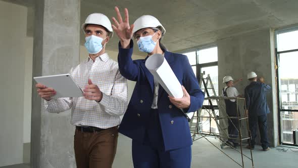 Masked Designers Discussing Apartment Renovation