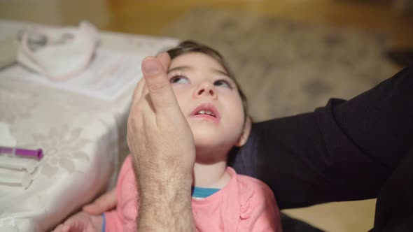 Beautiful child with cerebral palsy had a seizure and father soothes her with compassion and love wh