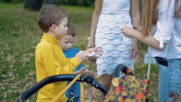 Little Children Wipe Their Faces with Napkins