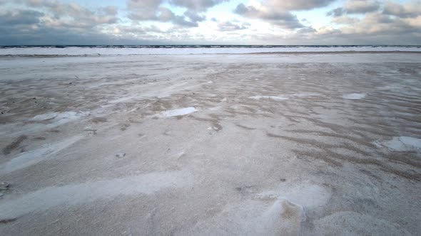 Close-up of Blizzard on Beach During a Winter Storm. Snow Blown Away From Beach Dunes During a Winte