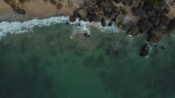 Beautiful Bingin beach with exotic cliffs houses and hotel located in Bali, Indonesia. This drone fo