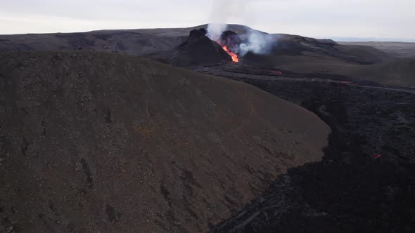 Active volcano emitting smoke and lava