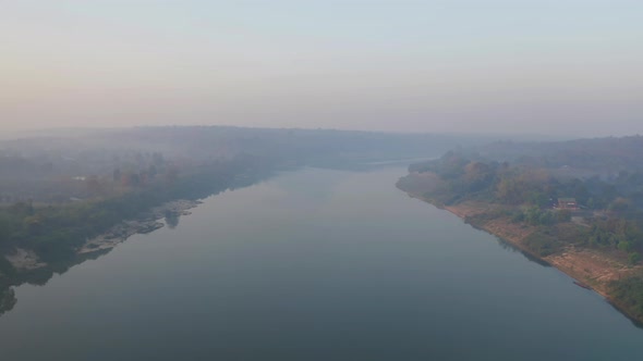 Aerial view of Mekong River with green mountain hill and mist fog. Nature landscape background