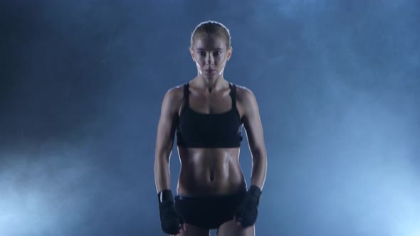 Sportswoman Boxer Warms Up the Muscles Before the Fight