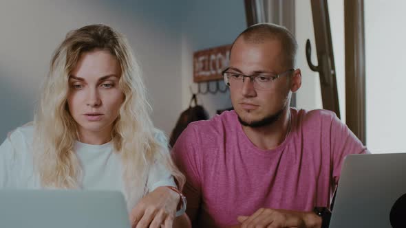 Young handsome man and woman work in cafe with laptop  using laptop browsing online