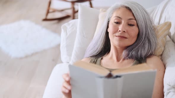 Asian happy woman reading book