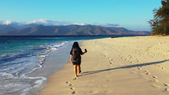 Tourist tans on paradise seashore beach wildlife by blue green sea and clean sandy background of the