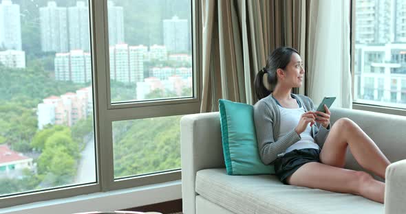 Woman using cellphone at home 