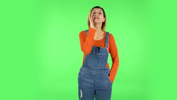 Girl Screams Calling Someone on a Green Screen at Studio