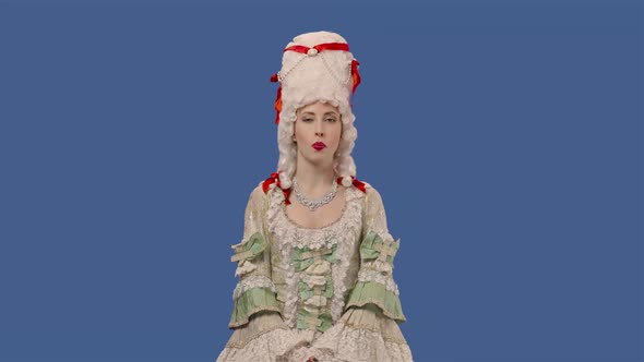 Portrait of Courtier Lady in White Vintage Lace Dress and Wig is Chewing Gum and Blowing Bubbles